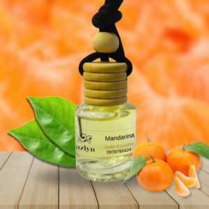 Difusor colgante para auto con aroma a Mandarina Jazlyn Perfumería , sobre fondo vibrante con mandarinas frescas, ideal para una fragancia cítrica, frutal y alegre en el auto